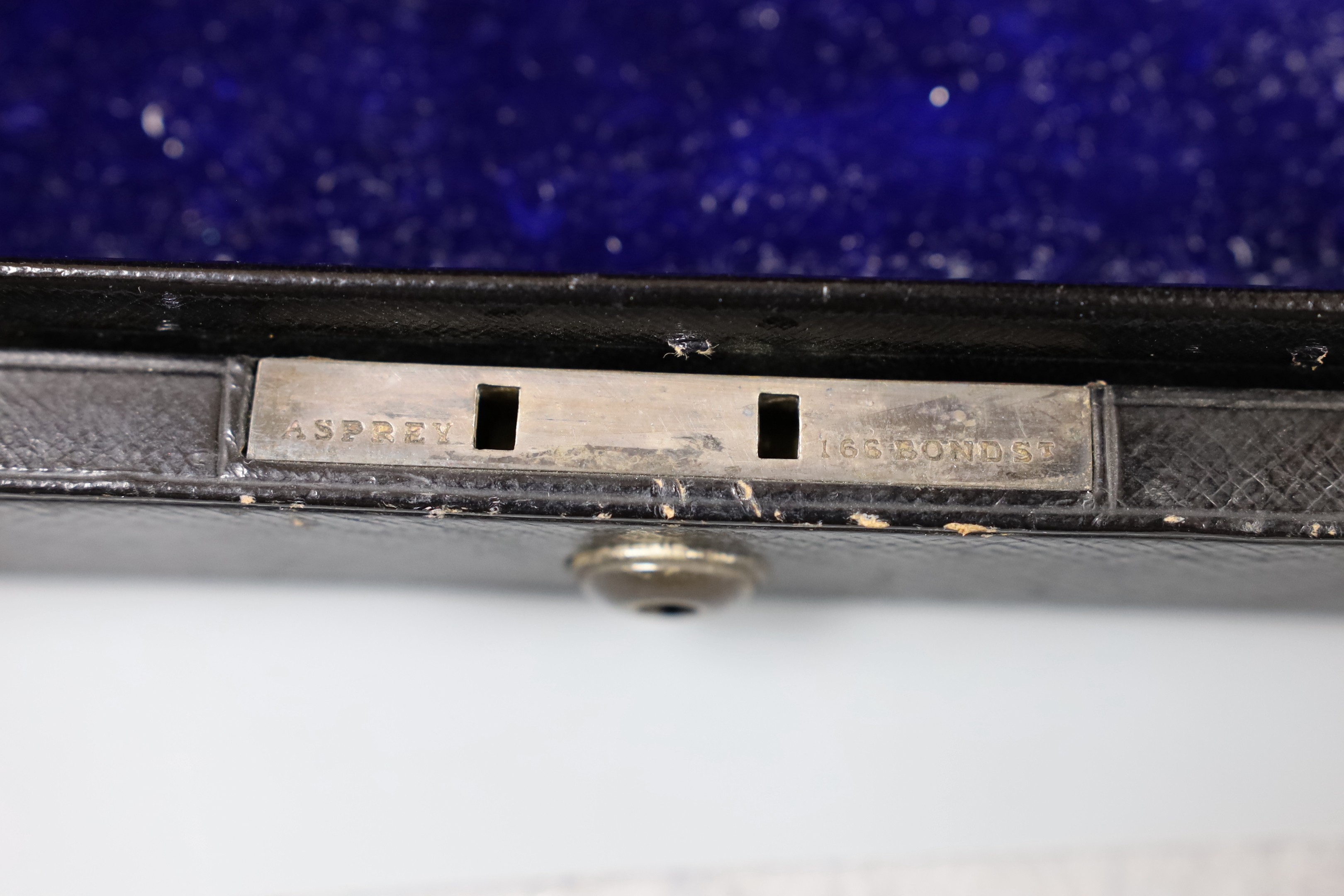 An Asprey & Co. Morocco leather jewellery box, with applied white metal monogram, 33.2cm width